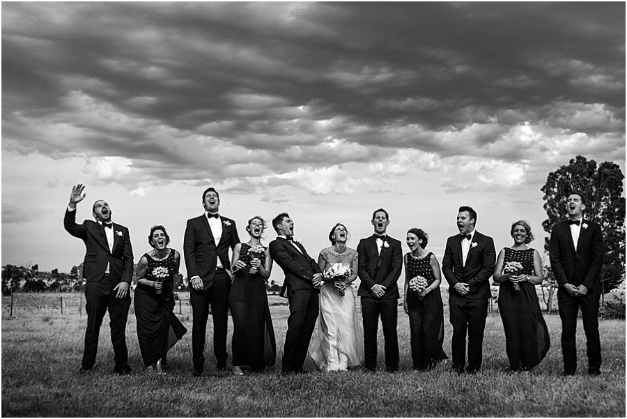 Laughing bridal party with great clouds