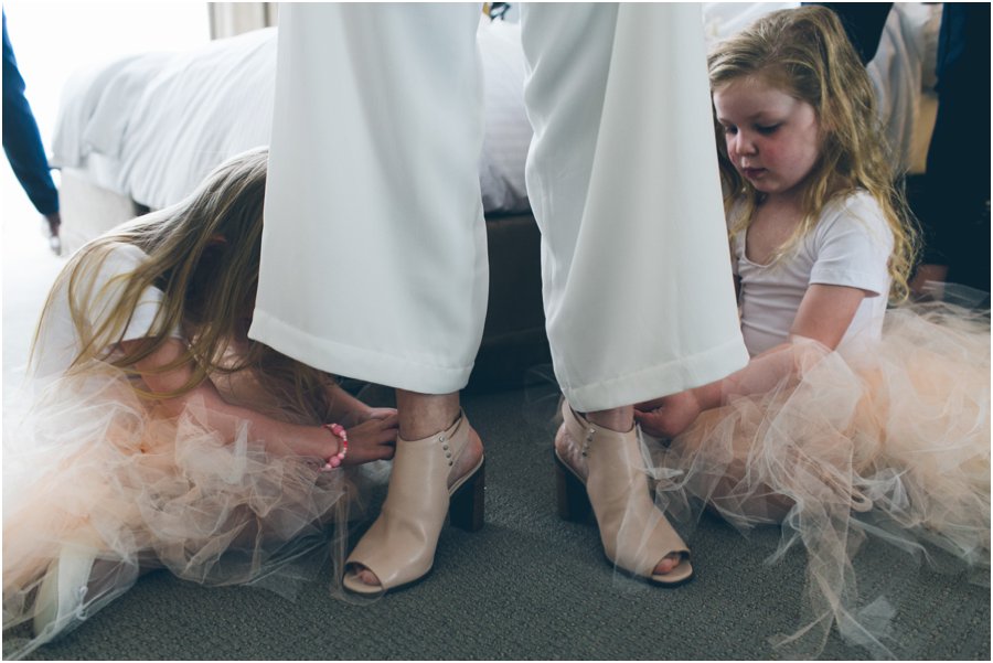 Two little girls helping Bride getting ready 