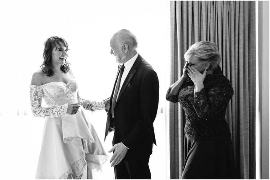 Emotive picture of parents seeing their daughter dressed up