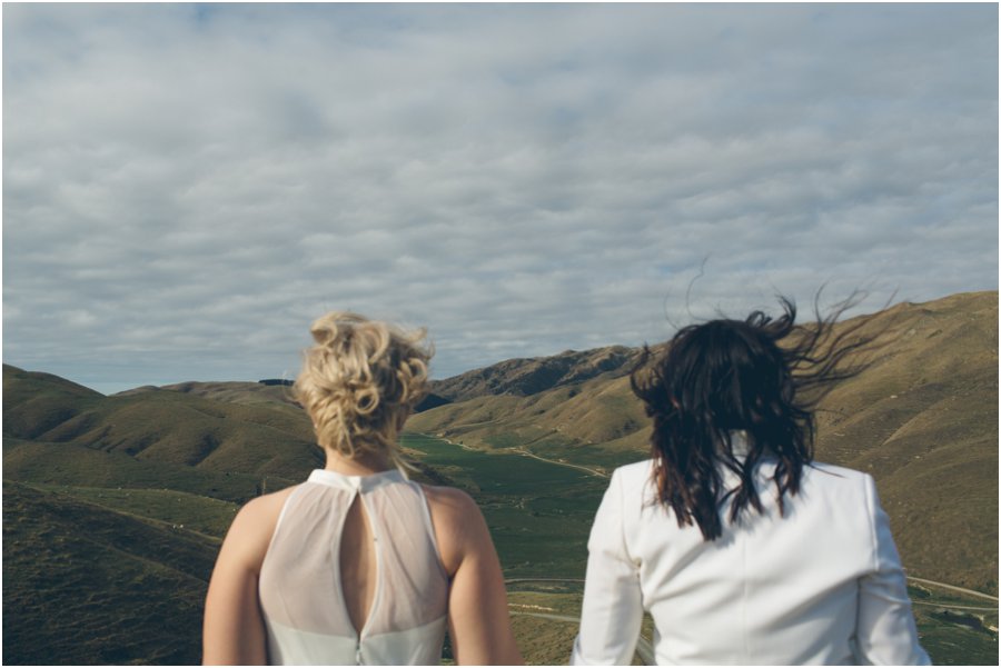 Two brides looking out, taking a moment