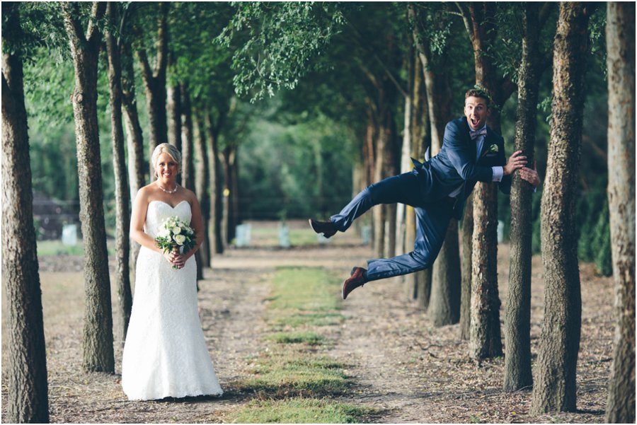 Yarra Valley wedding venues - Quirky shot of couple with the groom jumping - Alowyn gardens 
