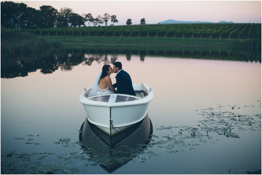 Yarra Valley wedding venues - Sunset pic of couple kissing in a boat