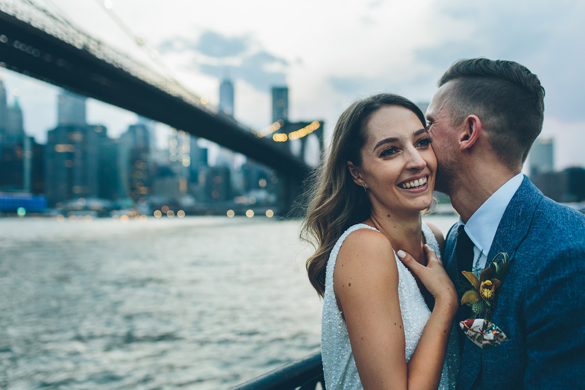 Laughing wedding couple at DUMBO New York