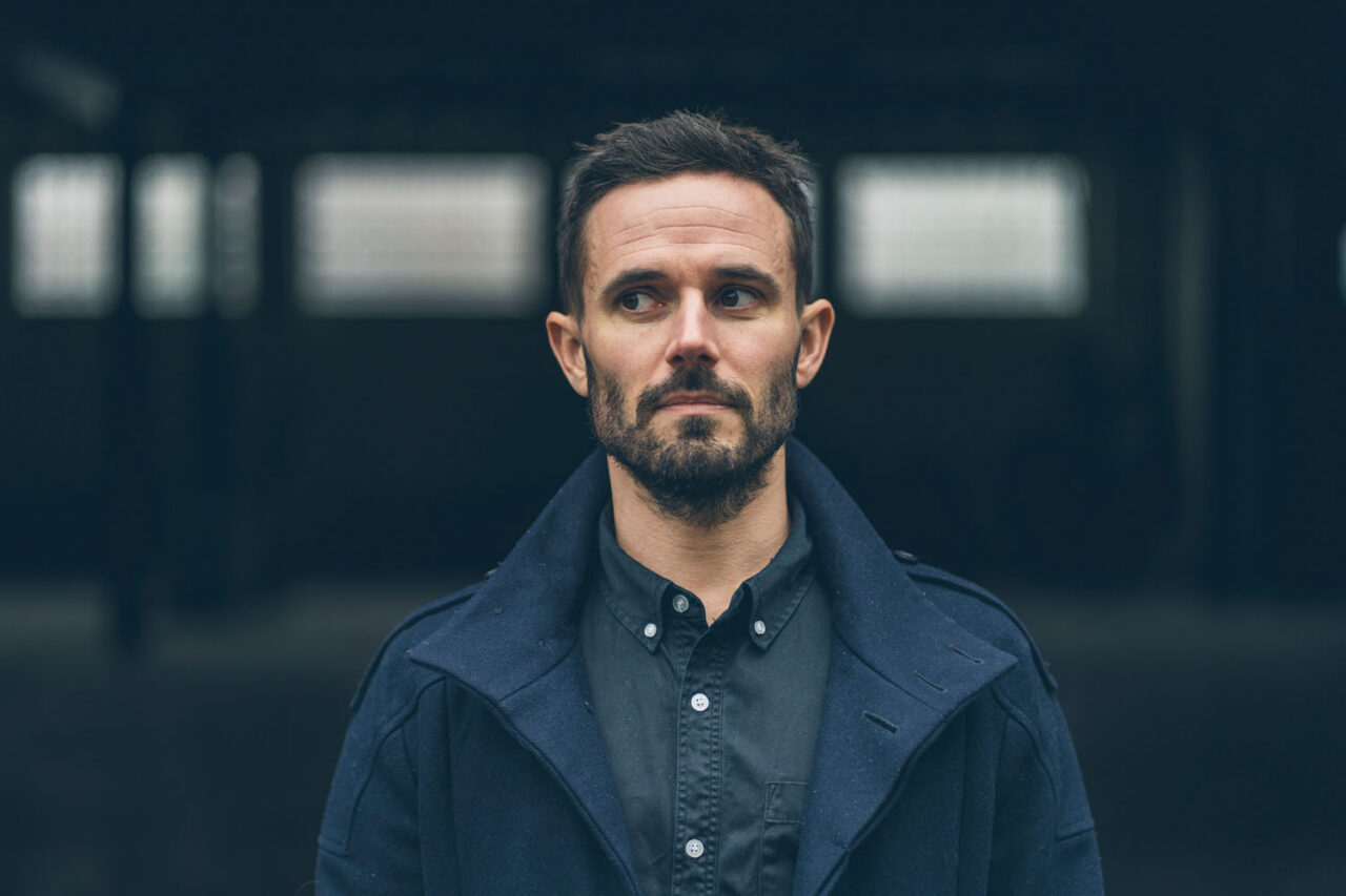 Moody professional headshot in Melbourne with dark architectural backdrop