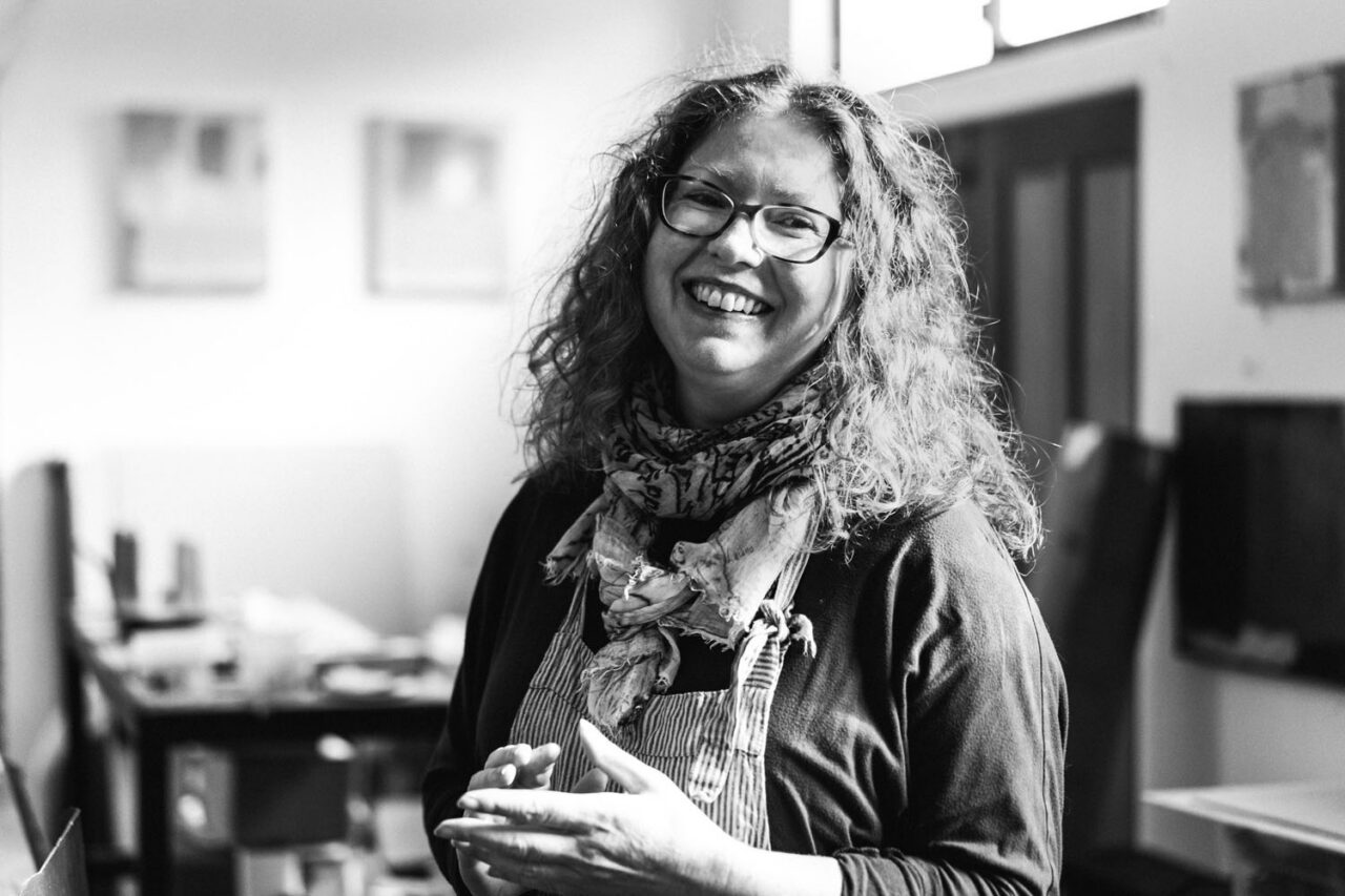 Black and white headshot of Surf Coast artist in her studio workspace