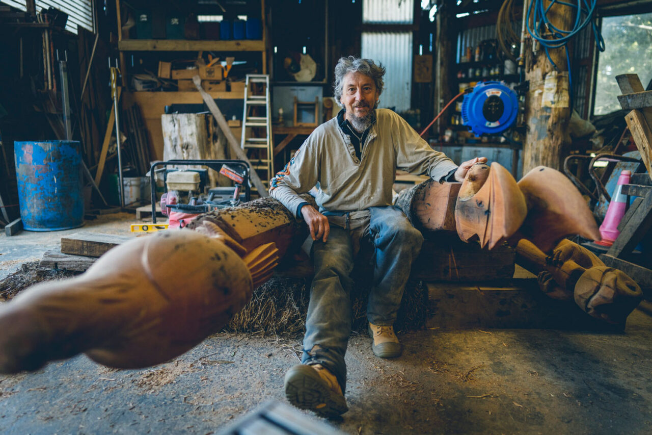 Environmental portrait of Surf Coast artist in workshop surrounded by sculptures