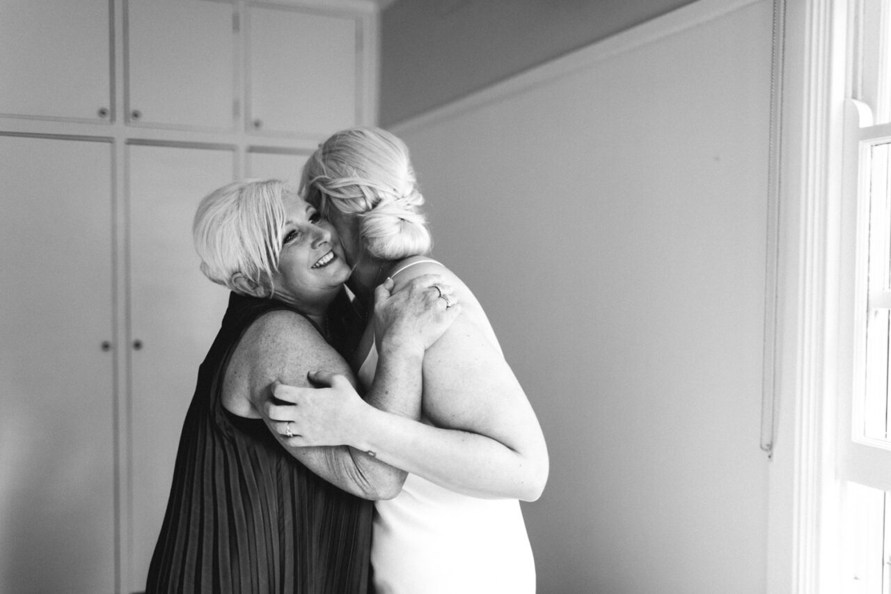 Emotional hug between bride and her mum during wedding morning preparations