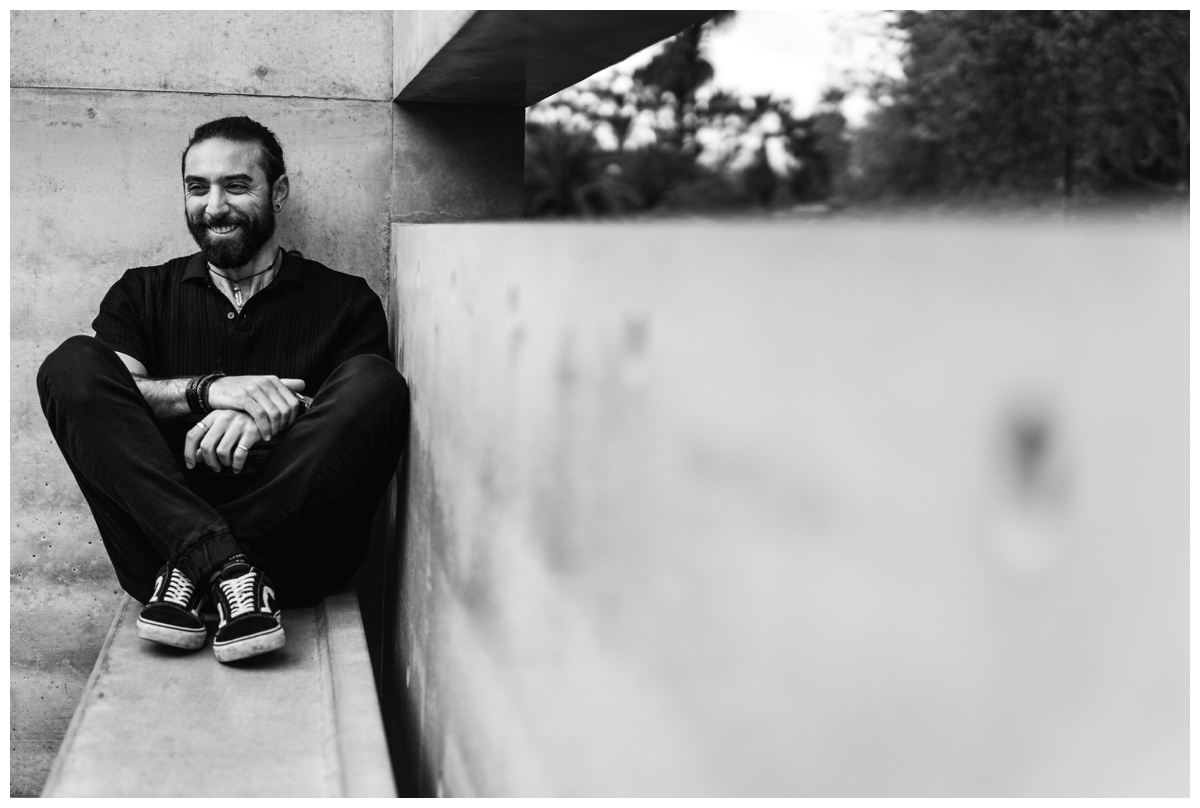 Black and white photo of tattoo artist laughing at the camera