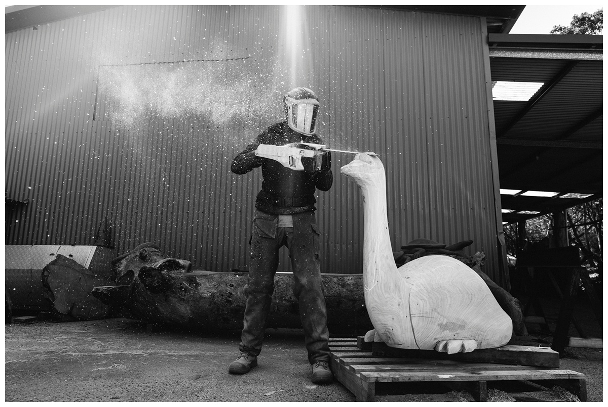 Sculptor with a chainsaw sculpting his art