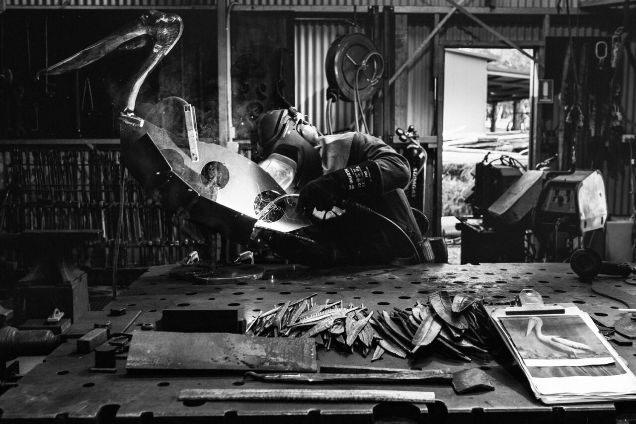 Wide shot of David Graham’s workshop as he welds