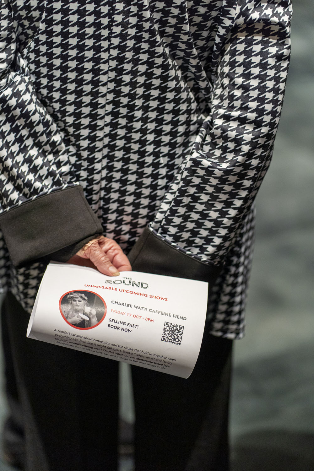 Close-up of an audience member holding a theatre program at The Round Melbourne, photographed by Lauren Marshall.