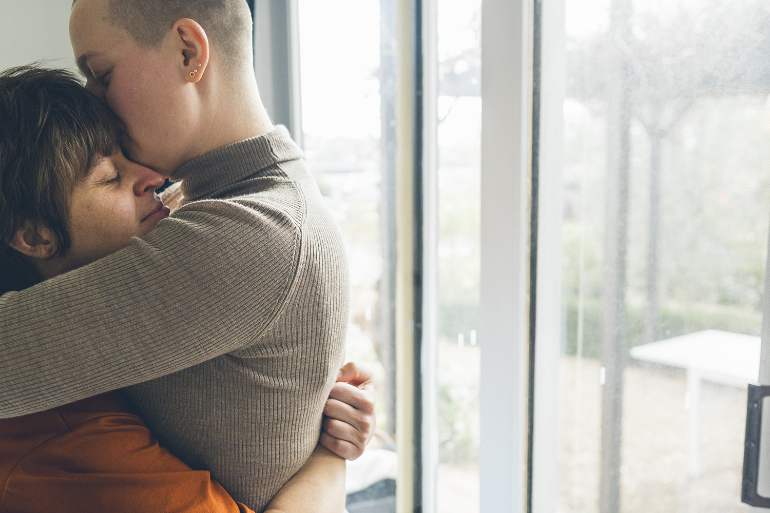 LGBTQI+ couple cuddling having an quiet moment