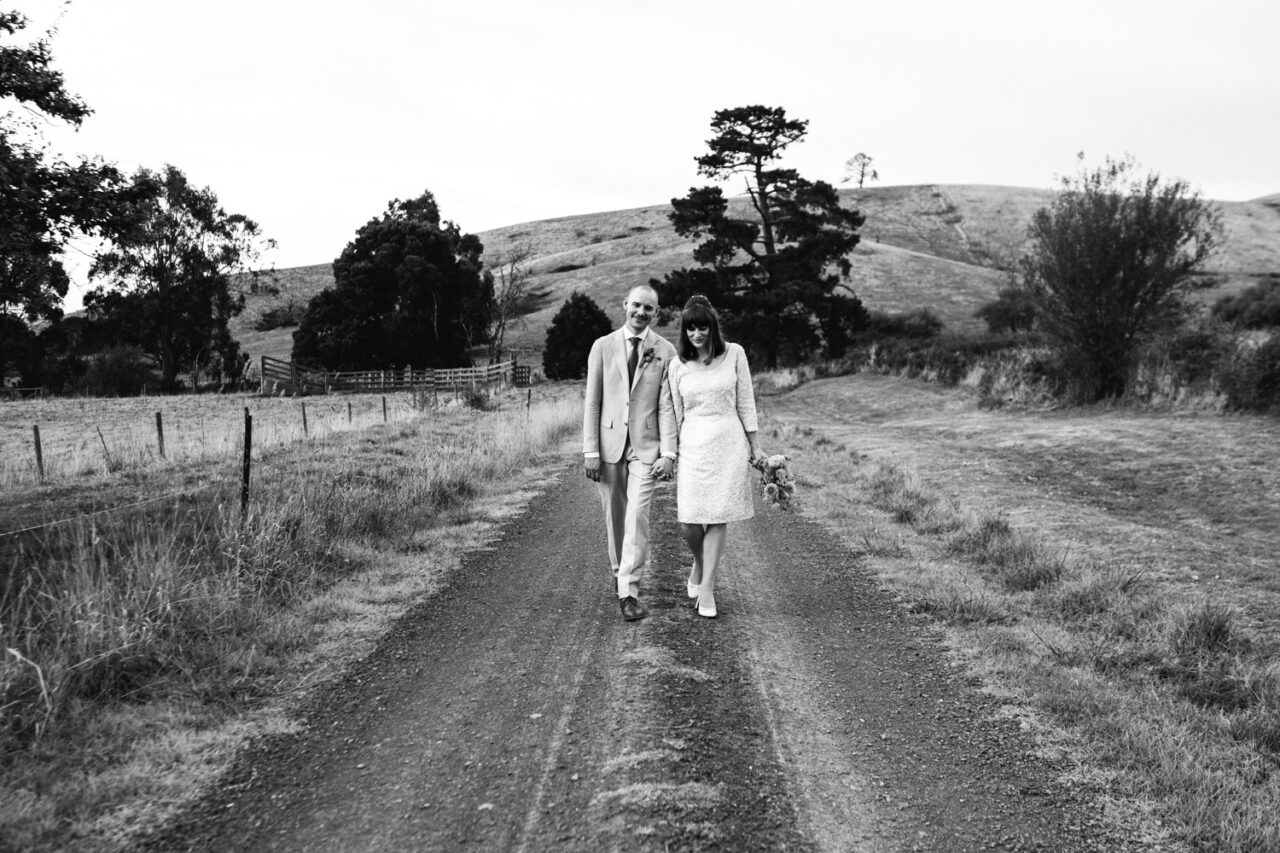 Couple walking together down a country road hand in hand