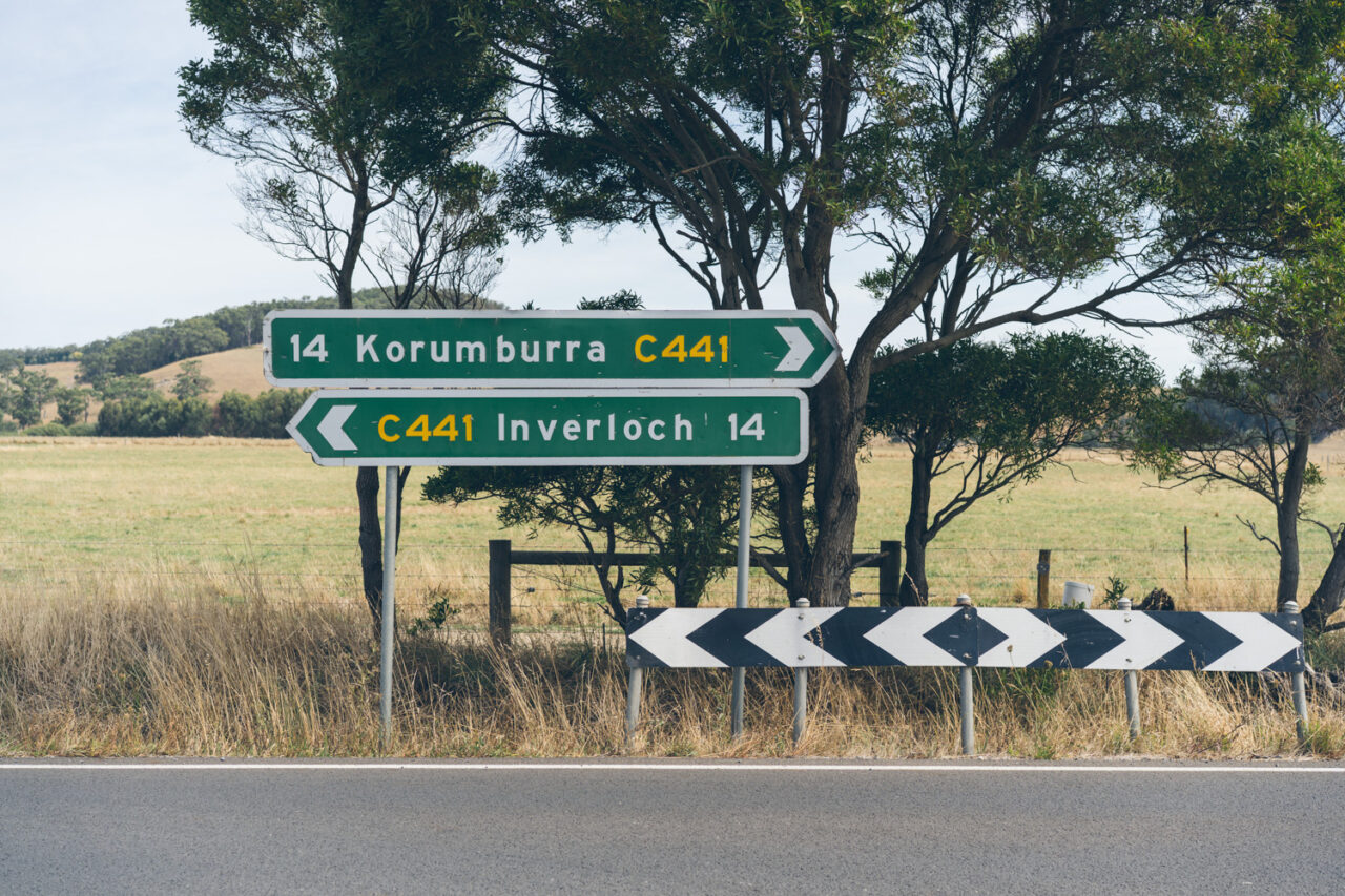 Country road sign showing directions to Korumburra and Inverloch on the way to Bel and Leigh’s regional wedding.