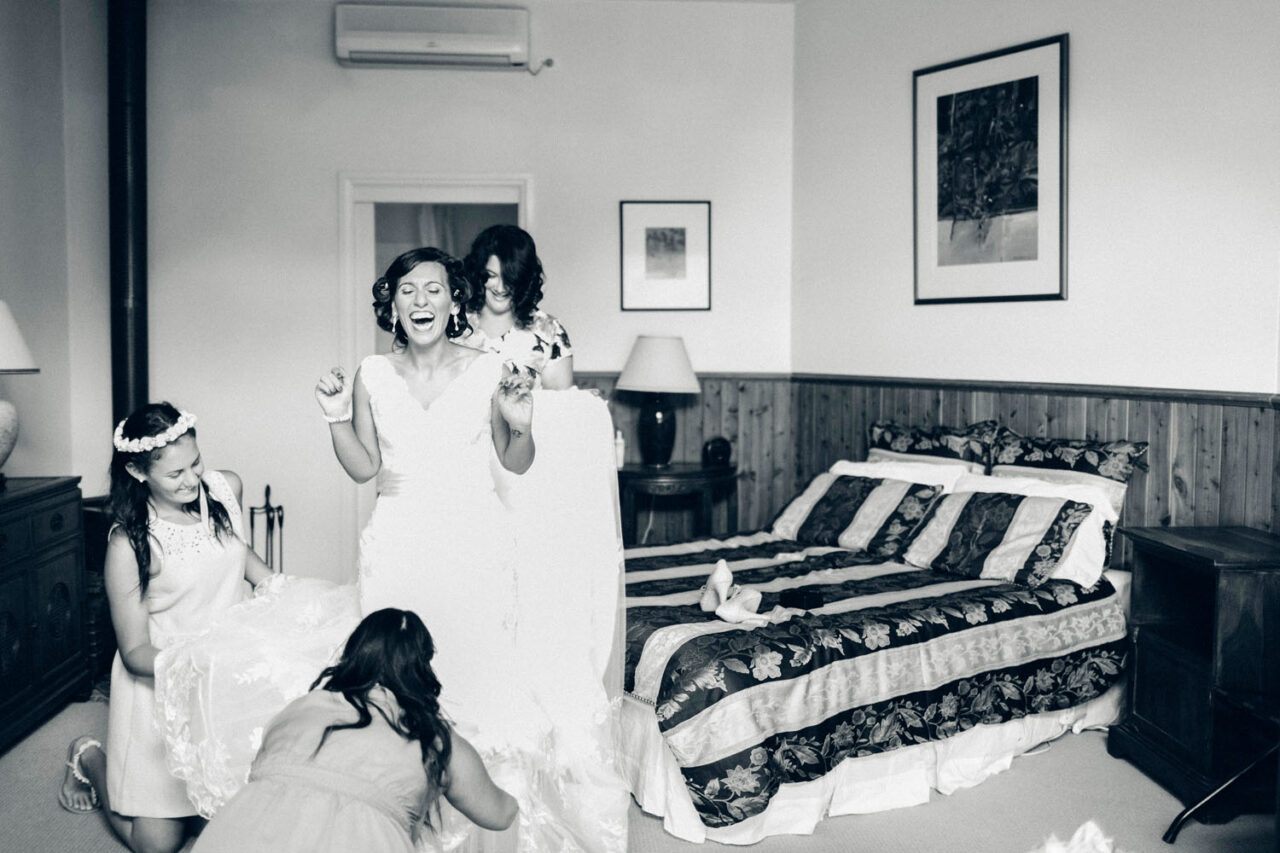 Inclusive wedding photographer on the Surf Coast documenting children helping a bride with her dress