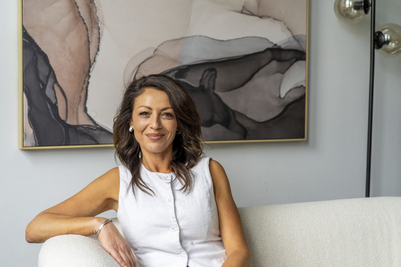 Relaxed portrait of a woman in her workspace, photographed in a natural, documentary style for authentic brand storytelling