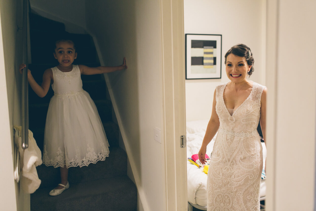 Bride and child sharing a surprised moment while getting ready, real and playful wedding story