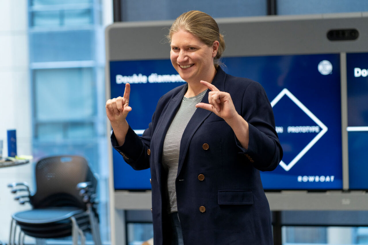 Female professional presenting to colleagues in a boardroom, documentary brand photography in Melbourne.