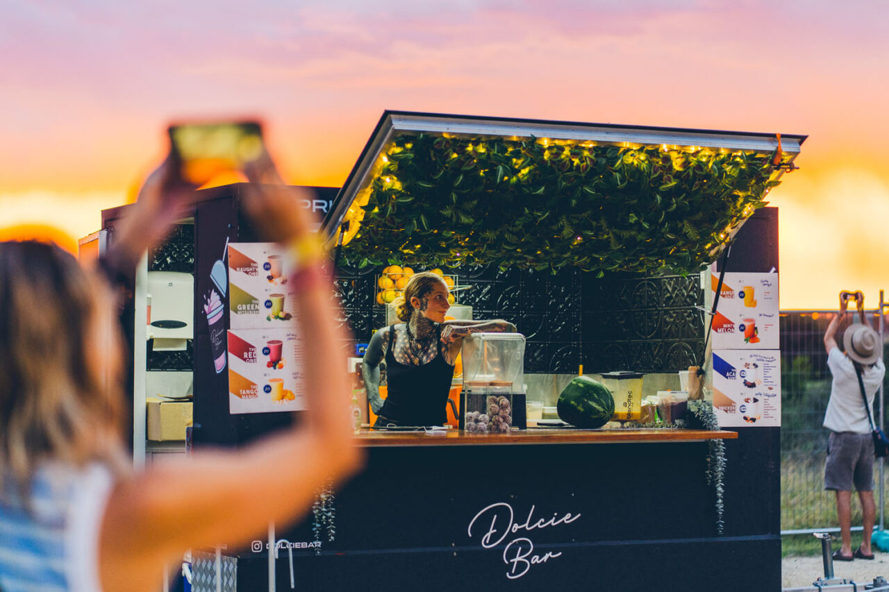 Juice bar food truck operating at sunset during an outdoor event