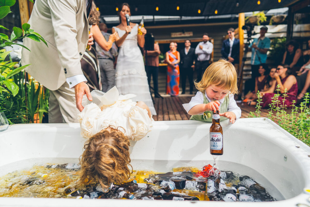 Kids playing in an ice bath during a relaxed backyard wedding reception