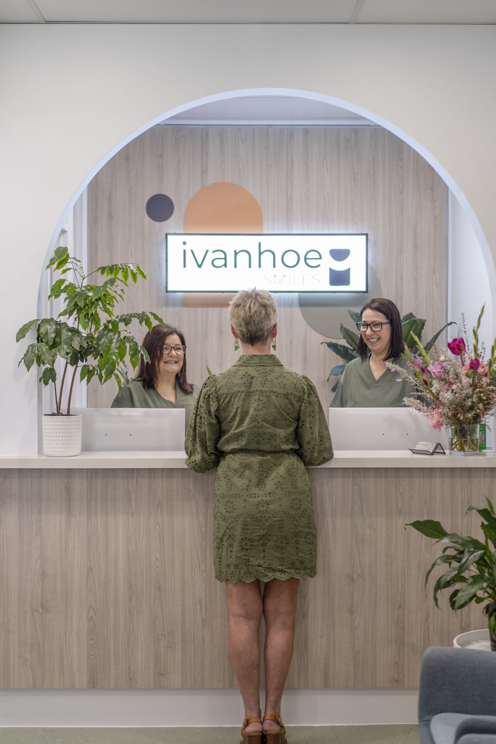 Client being welcomed by reception staff inside Ivanhoe Smiles dental clinic