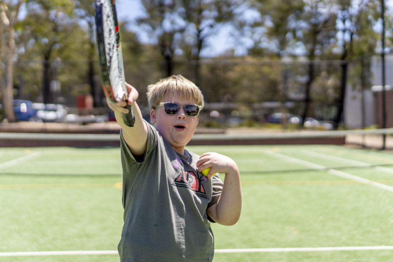 Community-focused photography capturing a young person engaged in sport and play