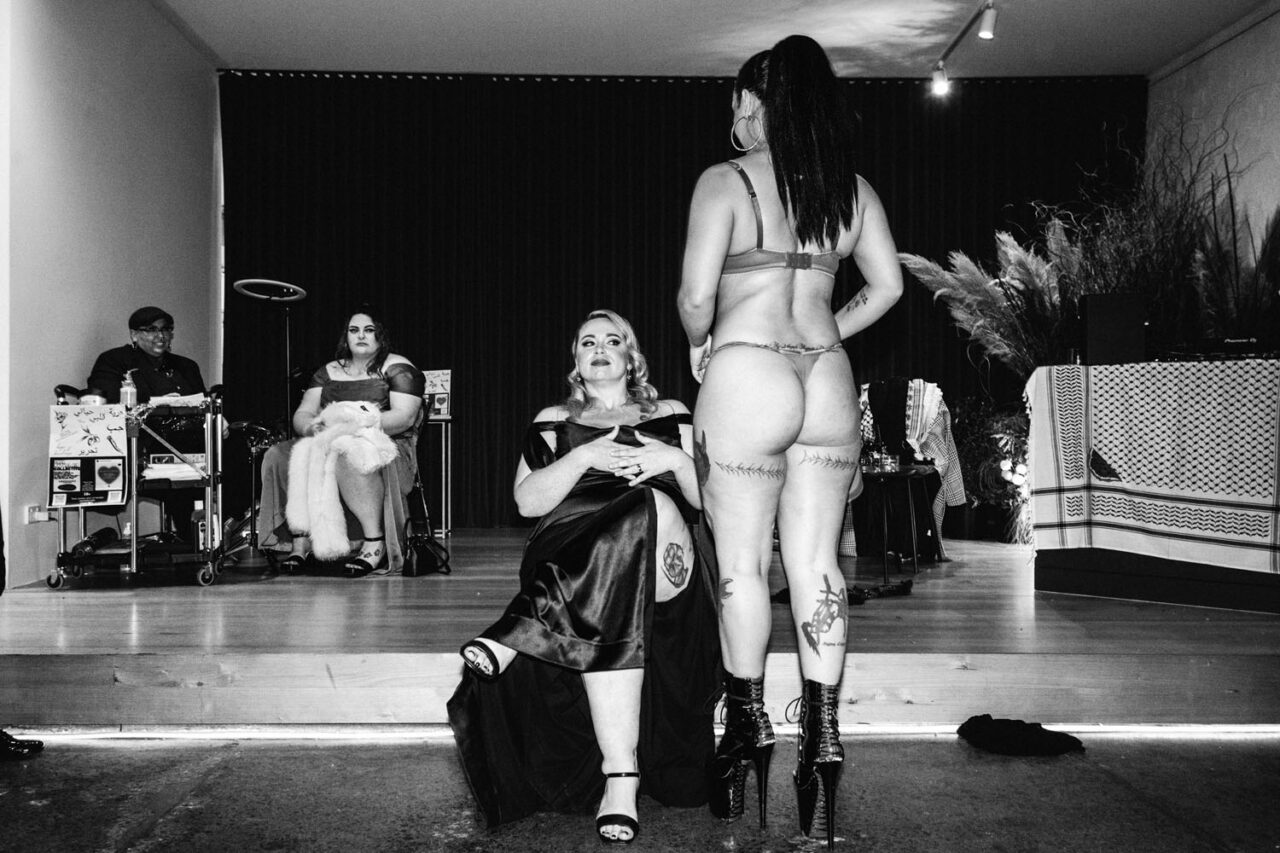 Burlesque performance during an inclusive wedding reception, capturing confidence, celebration, and non-traditional love in a documentary style.