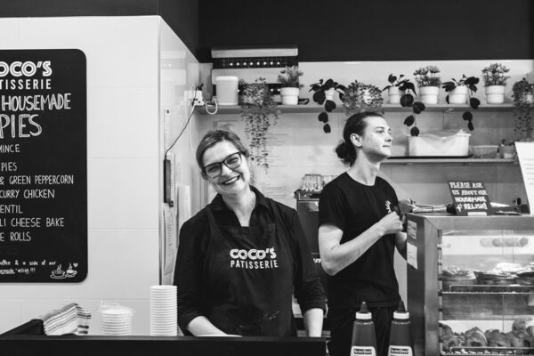 Lifestyle brand photography of a local cafe owner and staff working inside a small business patisserie