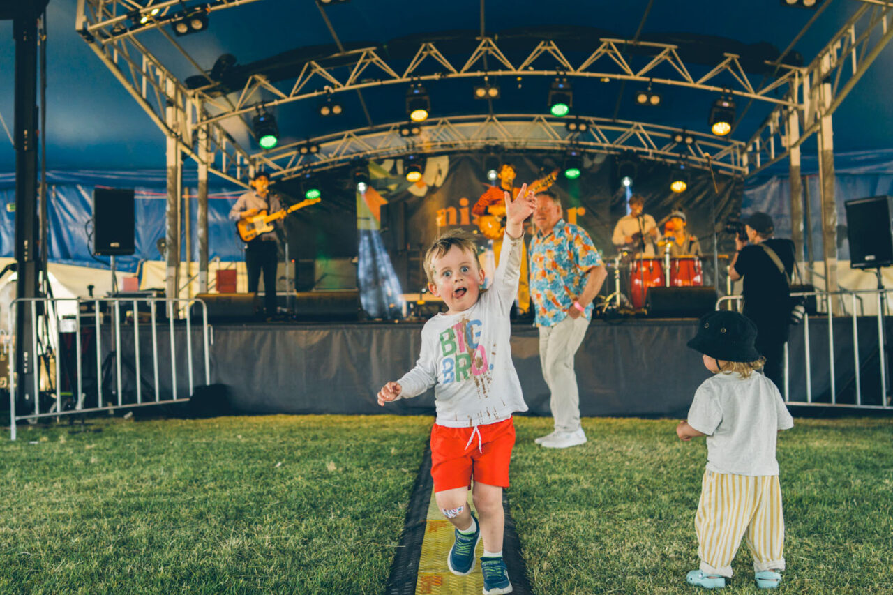 Young children dancing in front of a live music stage at Night Jar Market Torquay