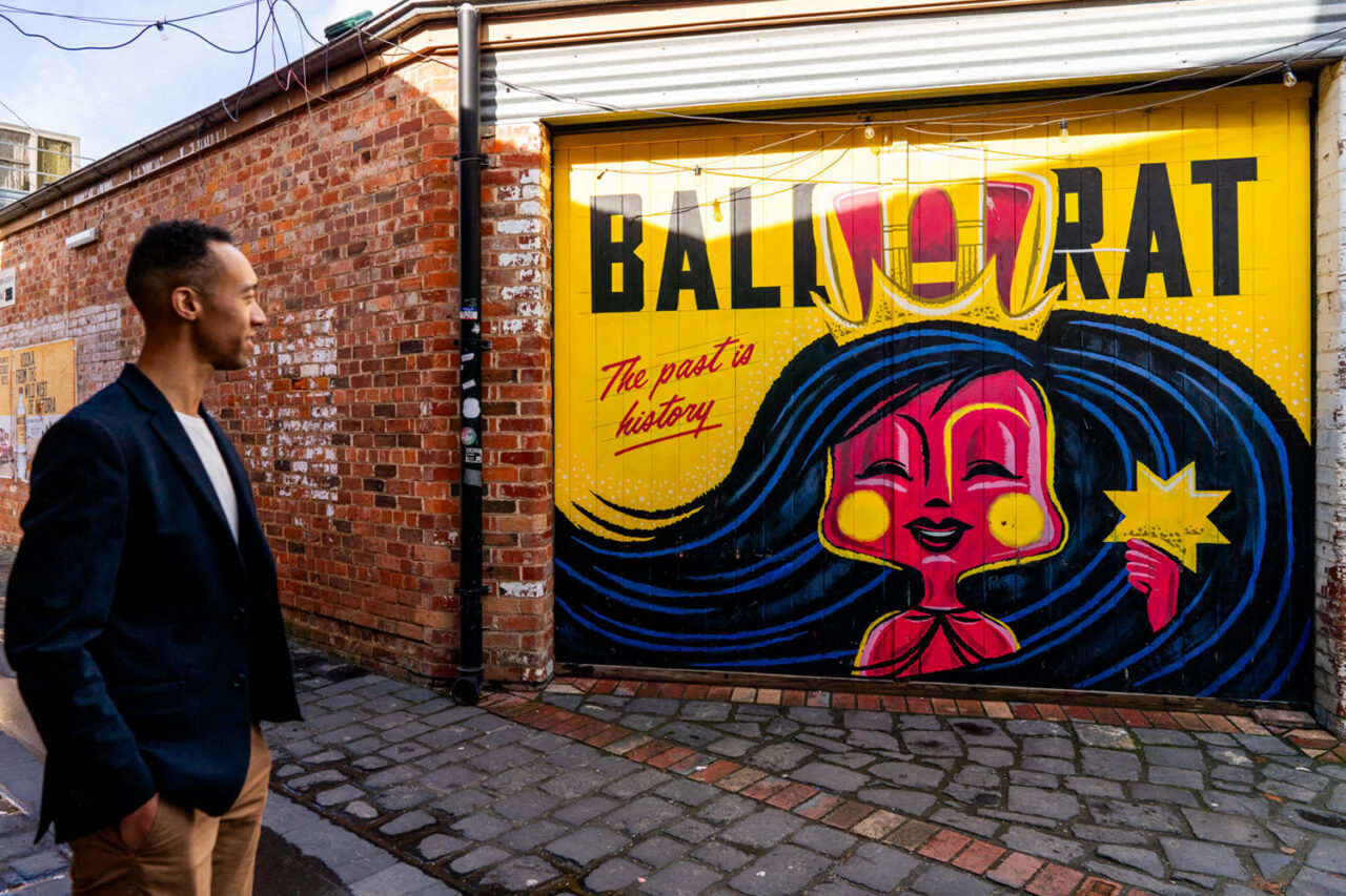 Person walking past a colourful mural in Ballarat, photographed as part of a documentary brand storytelling series