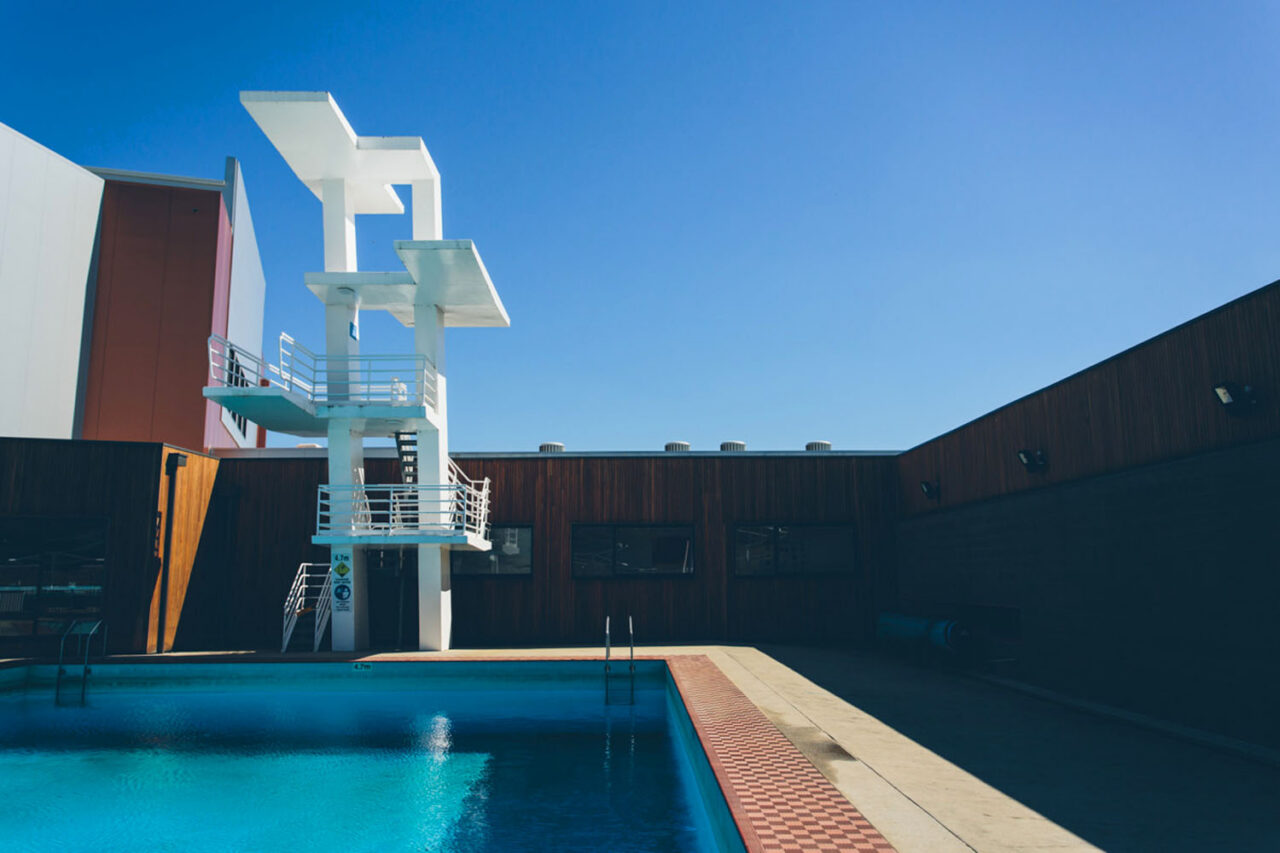 YMCA aquatic centre outdoor swimming pool with diving tower