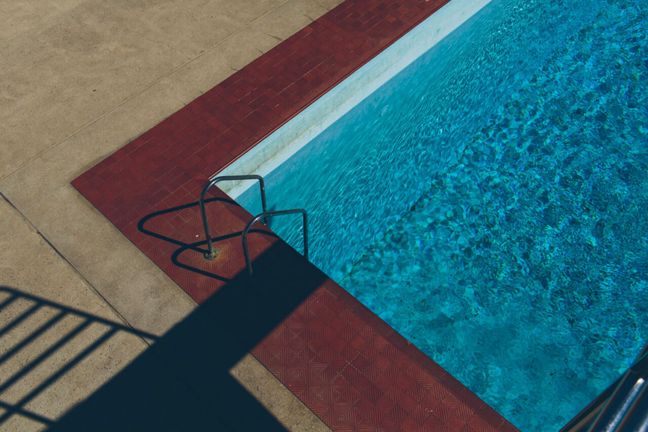 Shadow of pool ladder cast across YMCA aquatic centre swimming pool