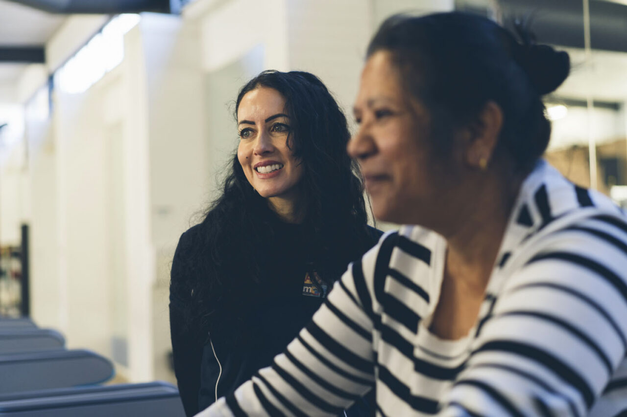 YMCA member with staff at the gym, documentary lifestyle brand photography.