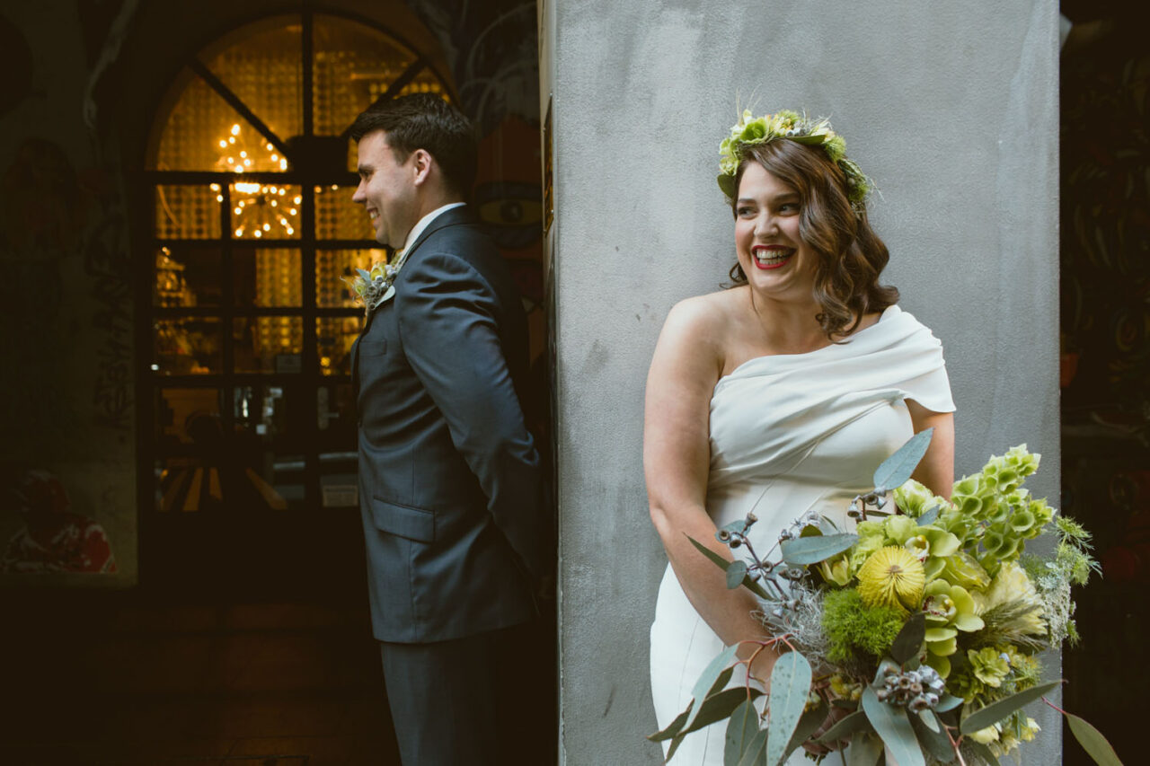 Bride holding a textured green and native style wedding bouquet created by Botanics of Melbourne.