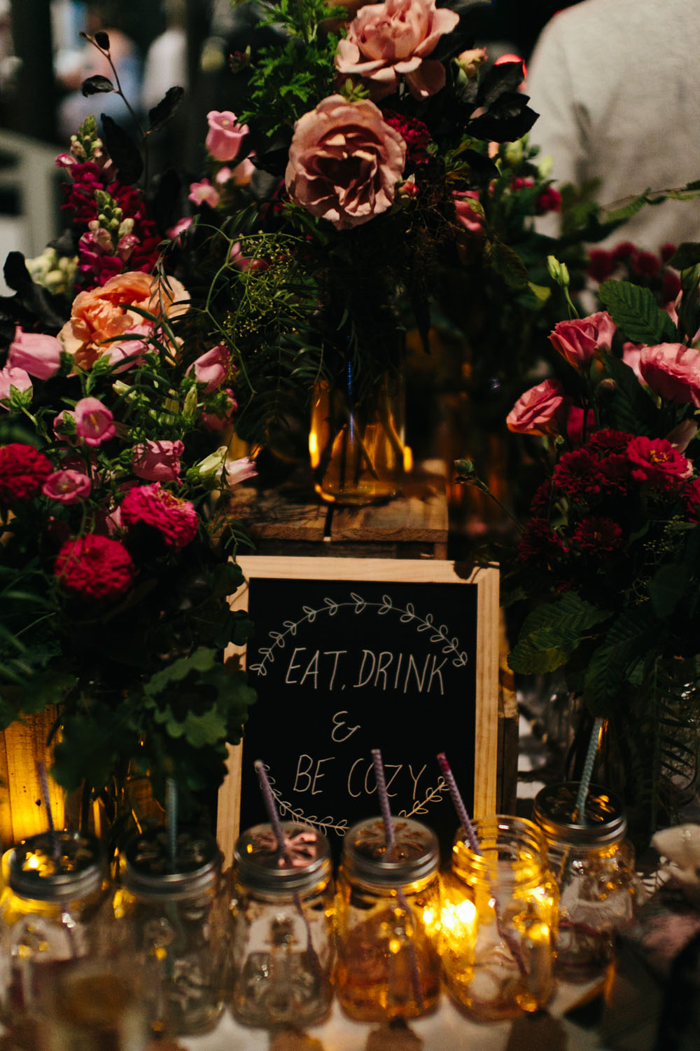 Wedding reception table styled with rich seasonal flowers and candles arranged by Botanics of Melbourne.