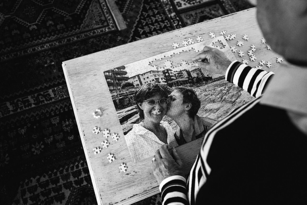 Guest completing a photo puzzle during a relaxed winter queer wedding in Daylesford.