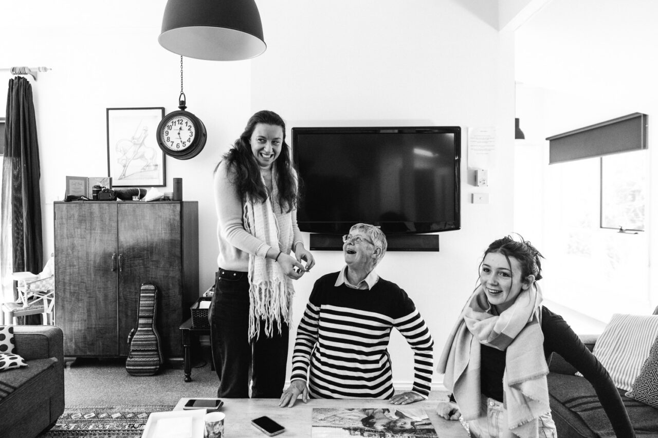 Family laughing together inside an Airbnb during an intimate queer wedding in Daylesford.