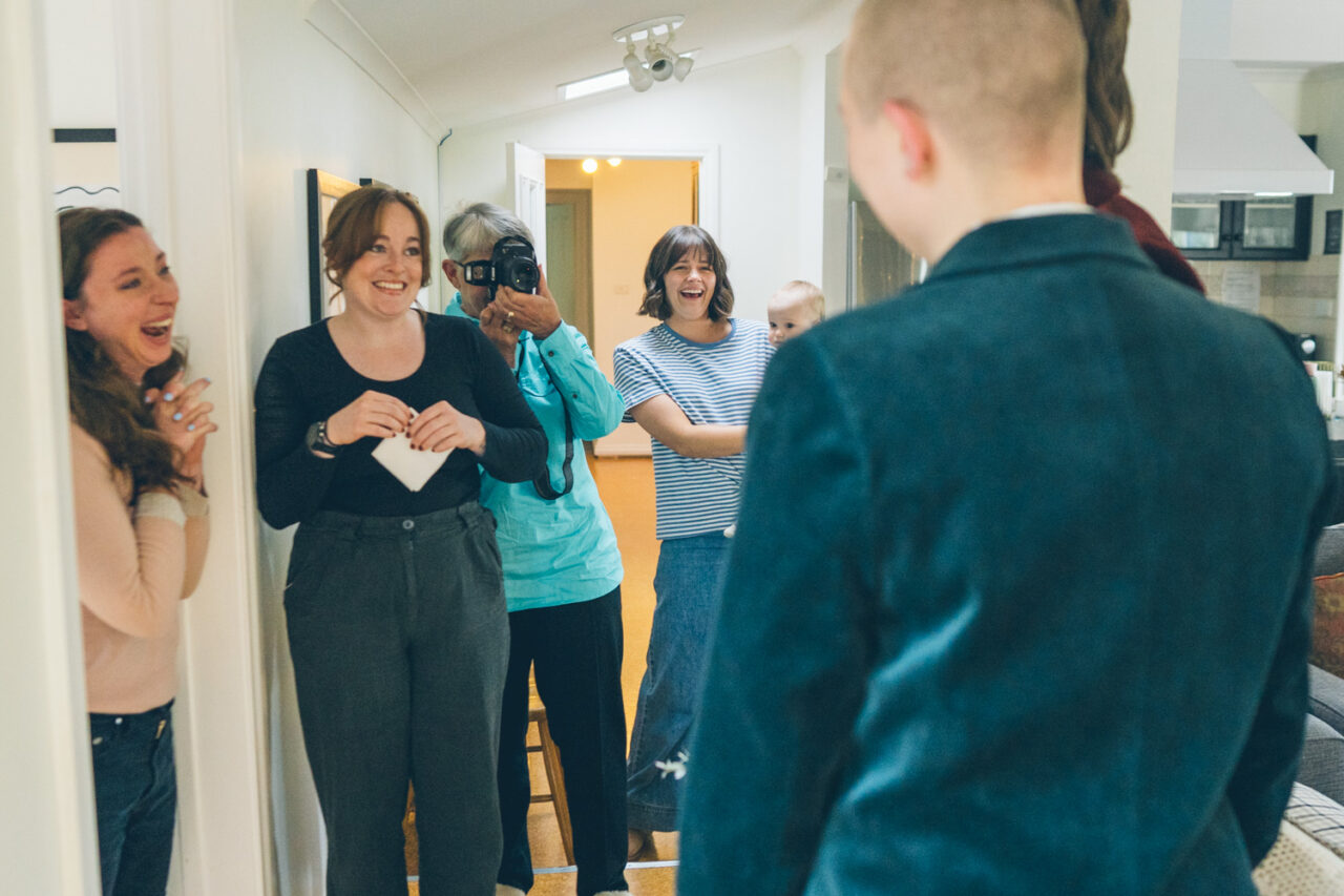 Family members reacting with laughter and emotion during a first look moment at an intimate Daylesford wedding.