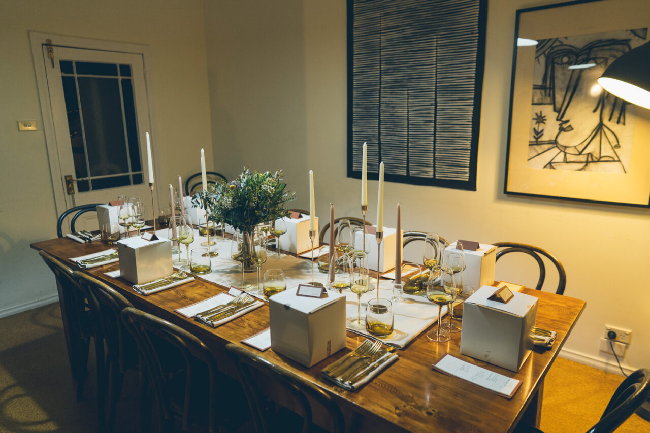 Candlelit dinner table styled for an intimate wedding reception inside a Daylesford Airbnb.