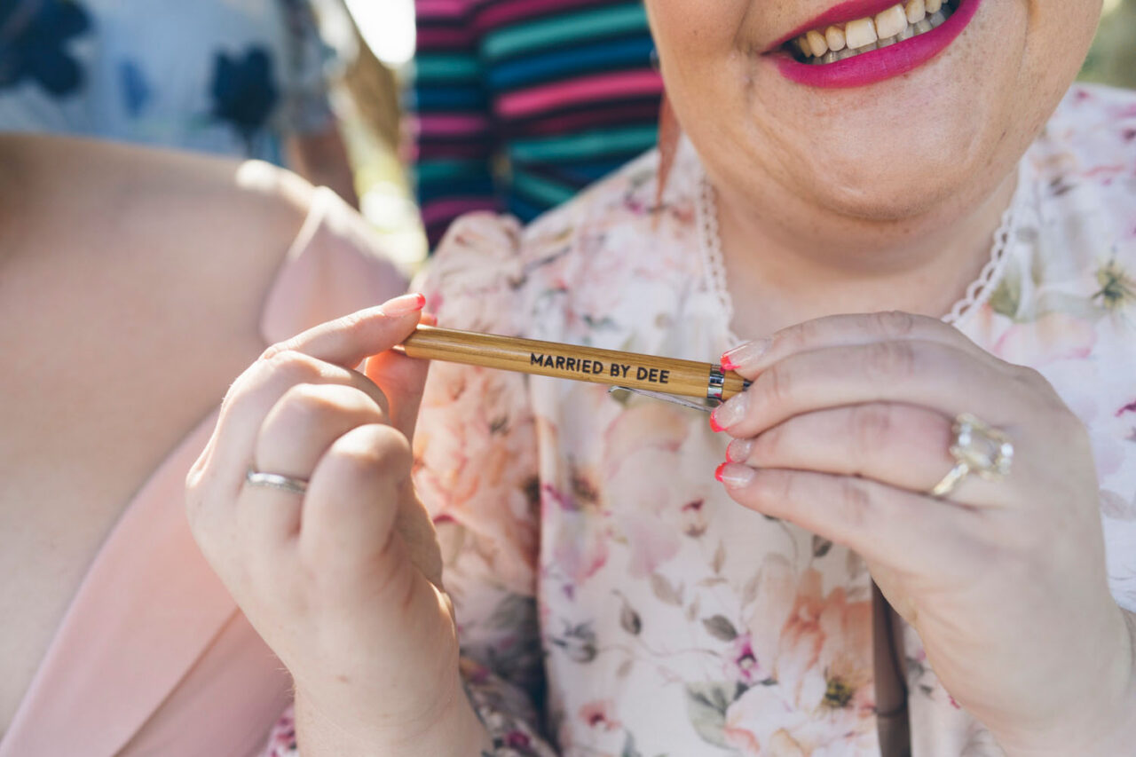 married by Dee pen held by couple during a queer wedding ceremony in Melbourne
