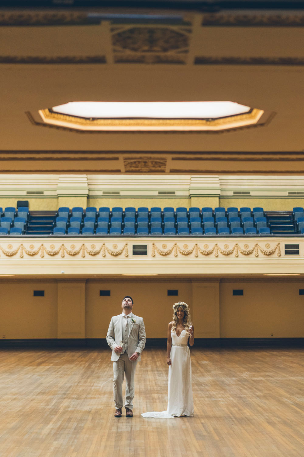 Couple standing in the grand hall of Melbourne Town Hall during their wedding portraits.