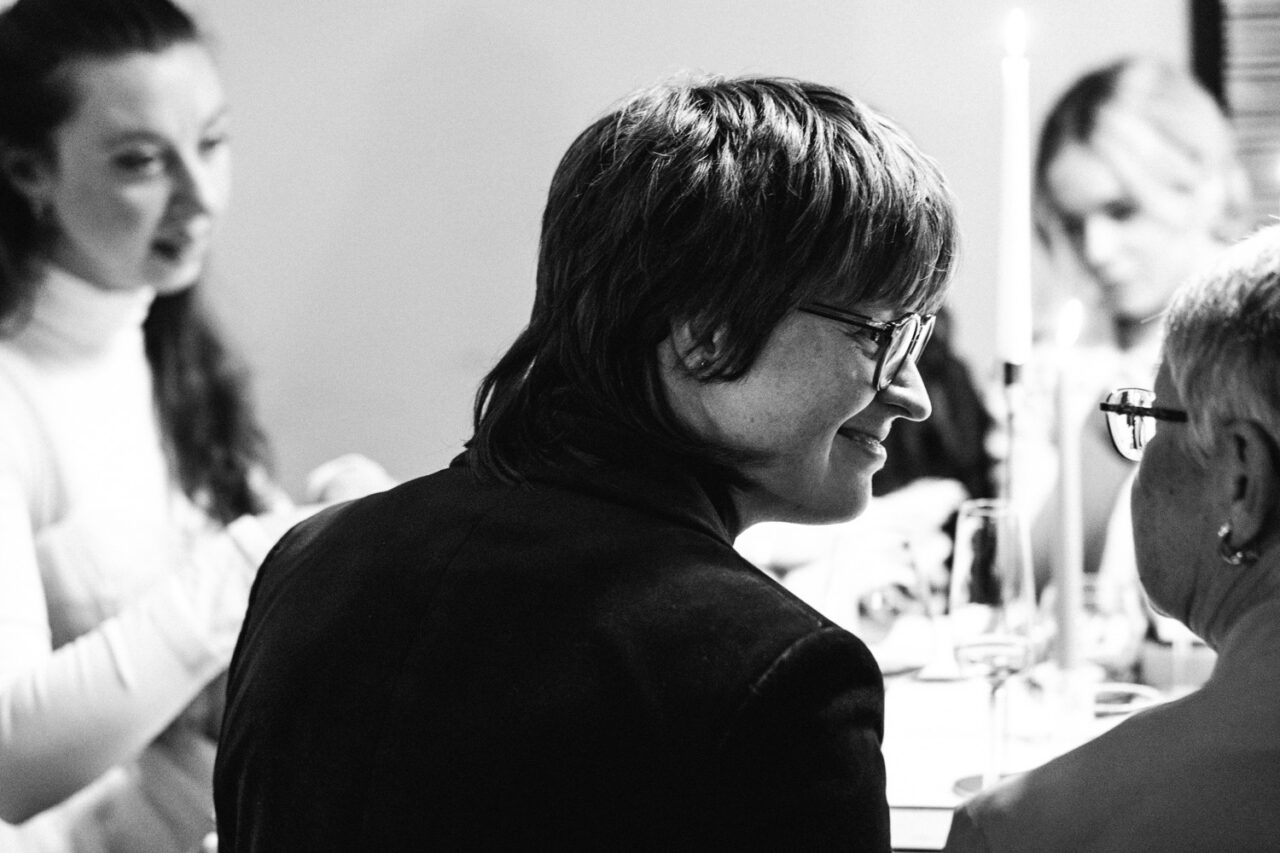 Bride smiling across the table during a quiet dinner moment at their Daylesford wedding.