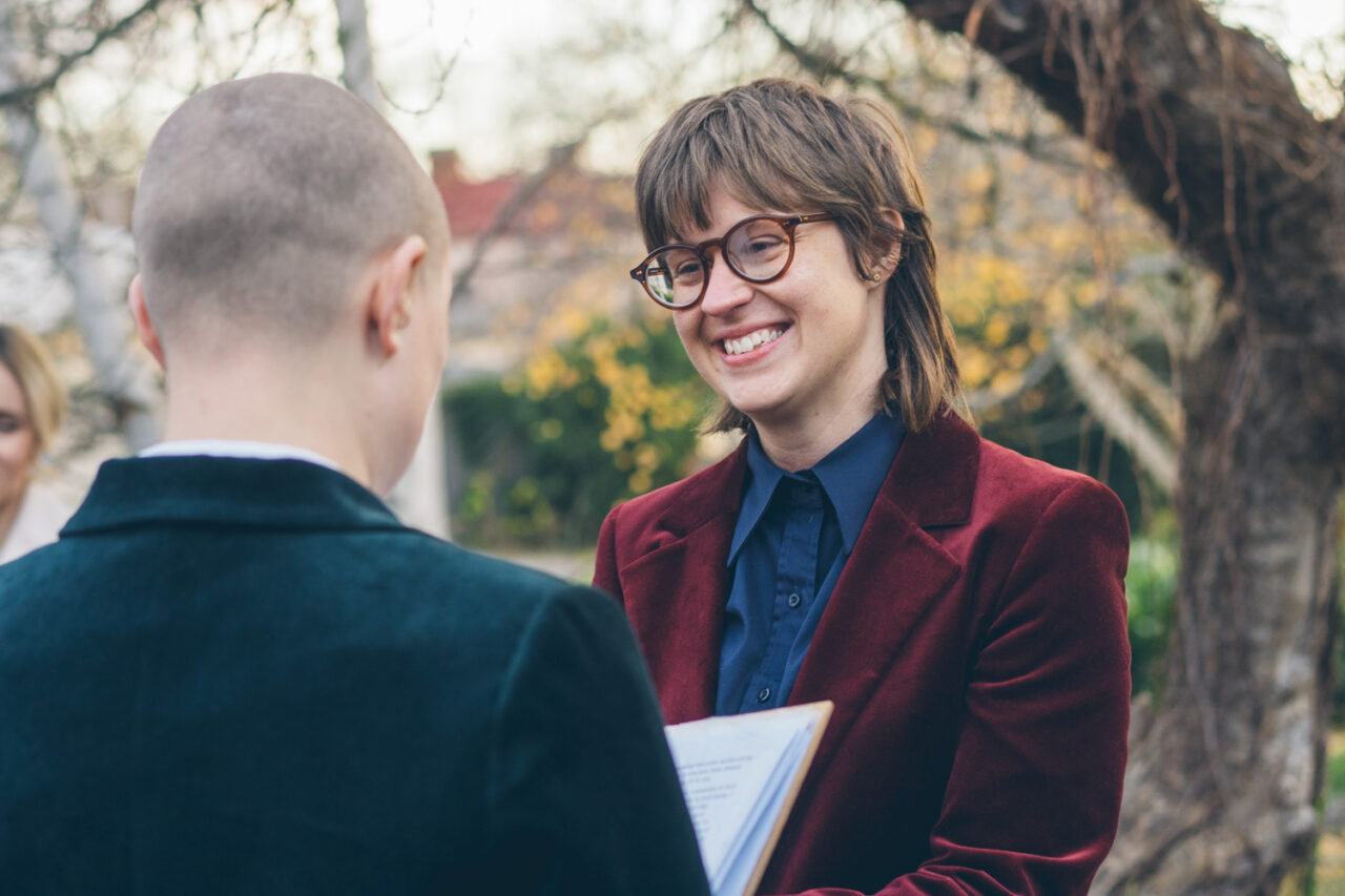 Bec smiling while reading vows during an intimate winter wedding ceremony in Daylesford.