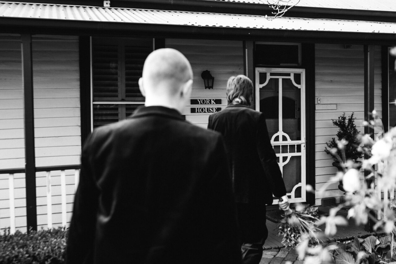 Naomi and Bec walking toward York House in Daylesford on their wedding day.
