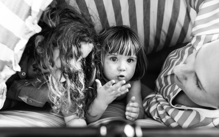 Two young siblings tucked in close together, captured in black and white during a Your Story documentary family session, Surf Coast Victoria 2025.