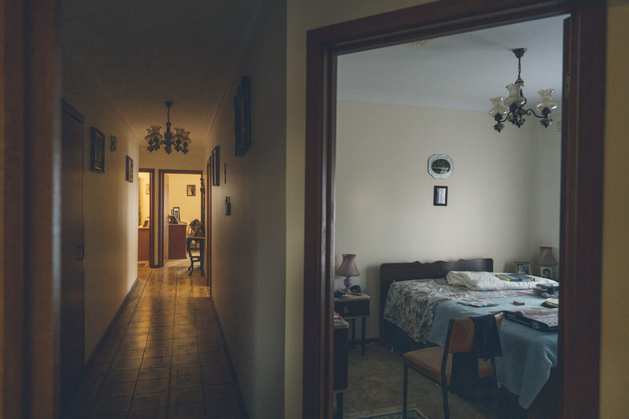 View from hallway into a bedroom and through the length of a family home, captured during a deceased estate photography session