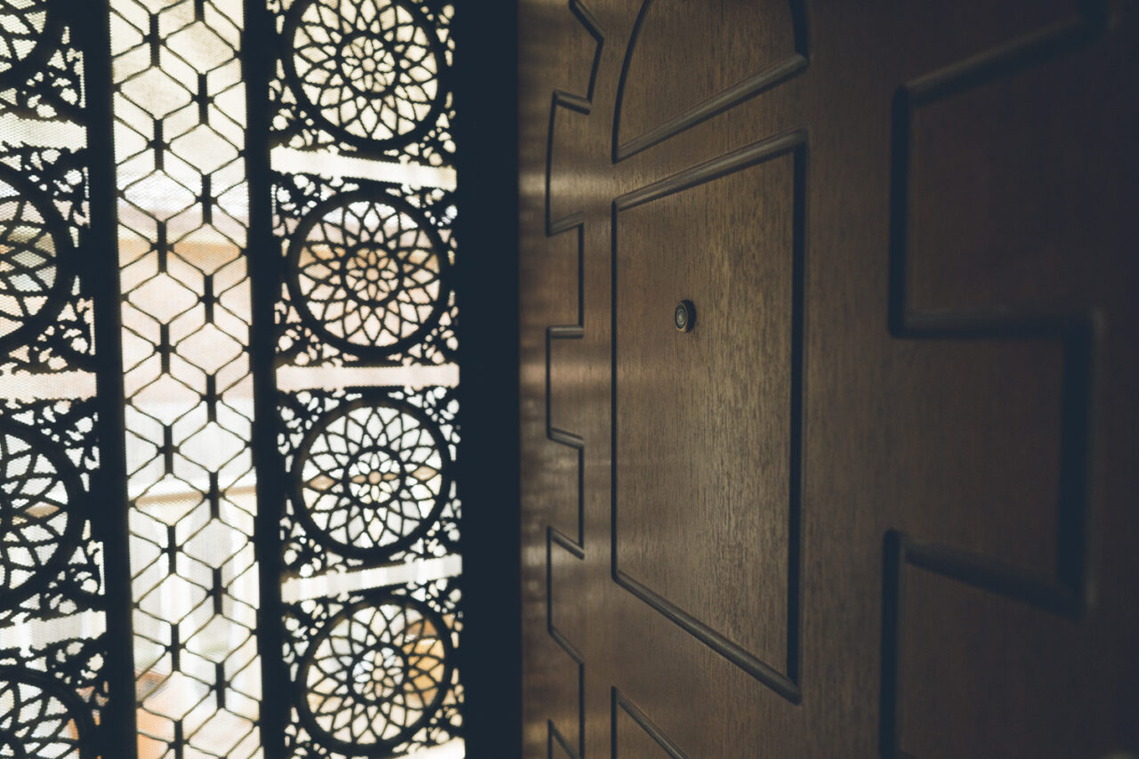 Ornate patterned screen door of a family home documented before sale, deceased estate photography Melbourne