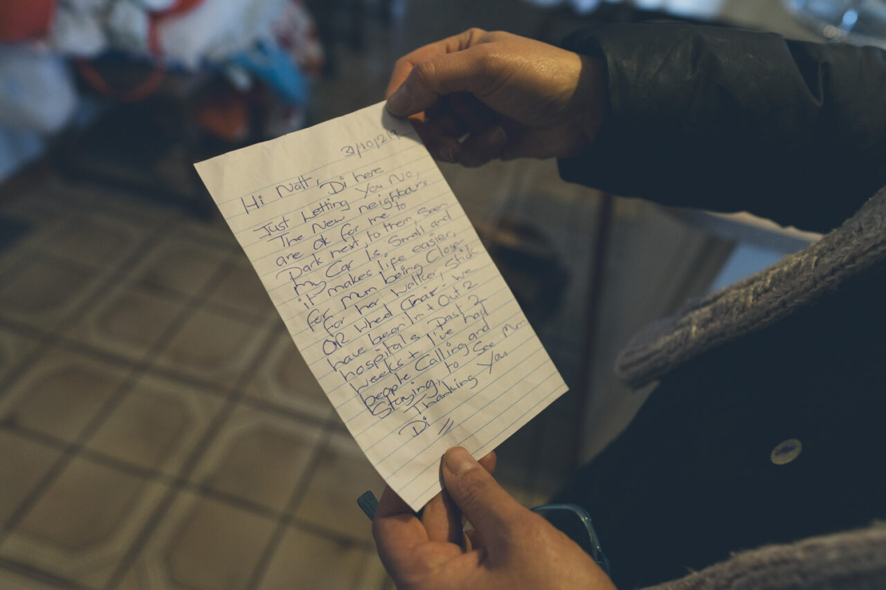 Hands holding a handwritten letter found during a deceased estate documentary photography session in Melbourne