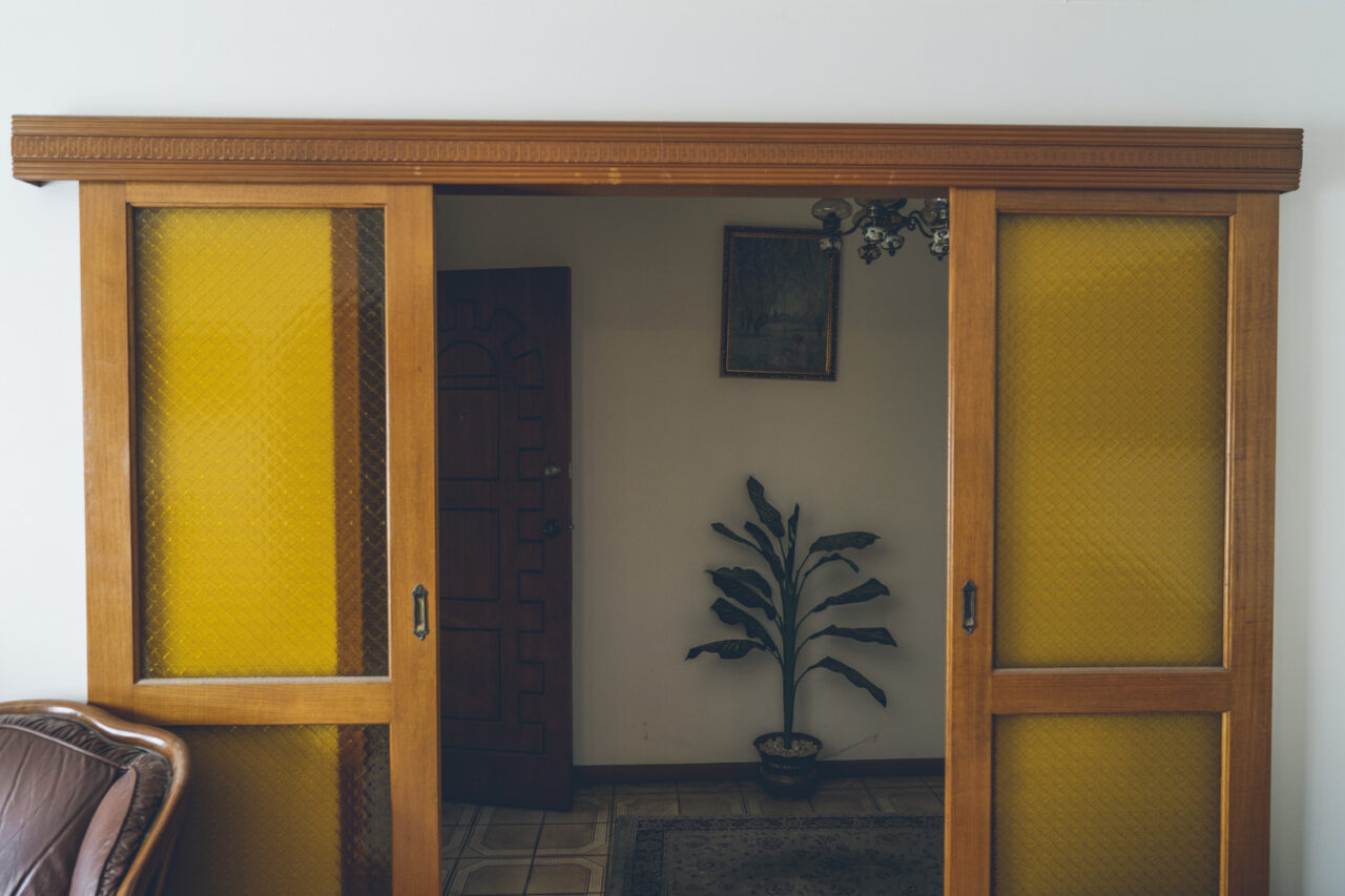 Vintage yellow glass sliding doors inside a family home documented before sale by LJM Photography Melbourne