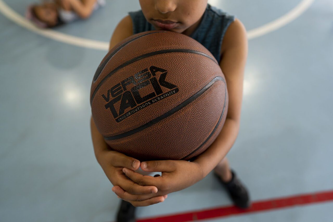 Overhead close up of a boy holding a basketball with both hands